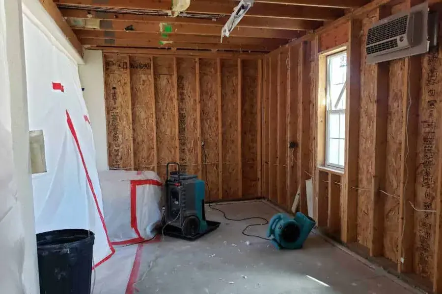 Dehumidifier and air mover drying a room in a Peachtree Corners home